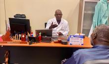 Professor Papa Ahmed Fall speaking to a client