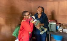 Kekeletso Theko, village health worker in Tsoelike village, Qacha'sNek helping a mother during the MR vaccination campaign