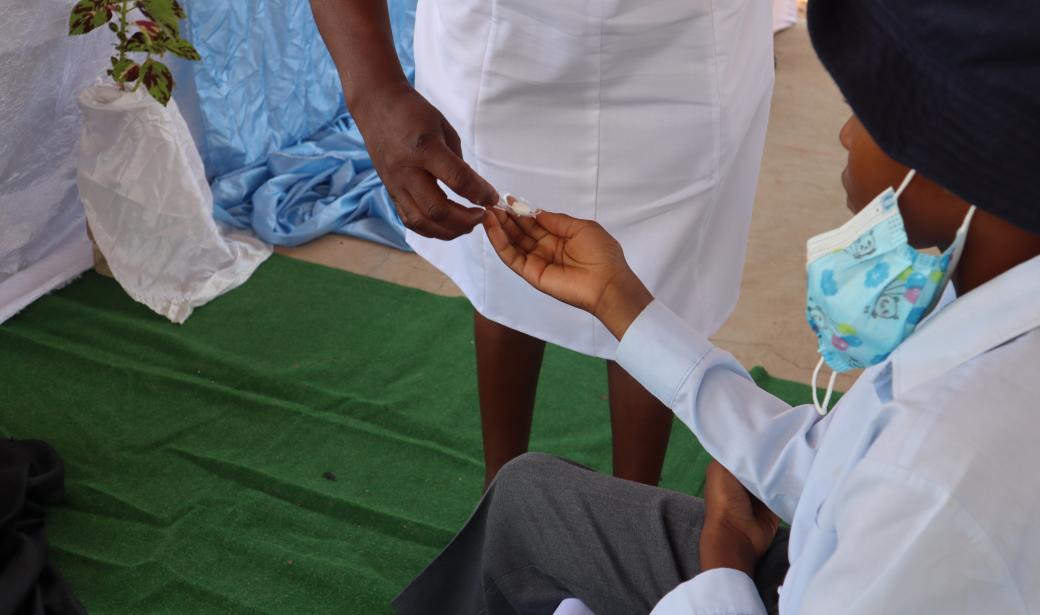 School boy receiving Albendazole, during the MDA exercise in his school in Kasane