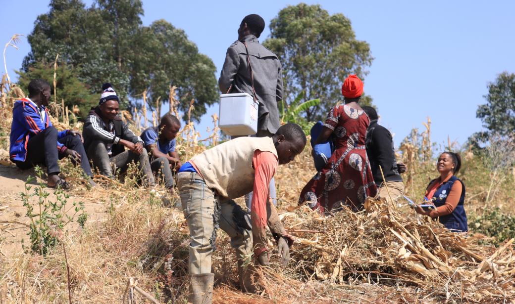 Magreth Nandi and vaccinator meet brick makers