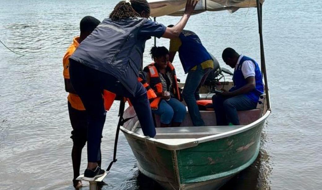 WHO team using a boat to reach communities cut of from the mainland in Ada